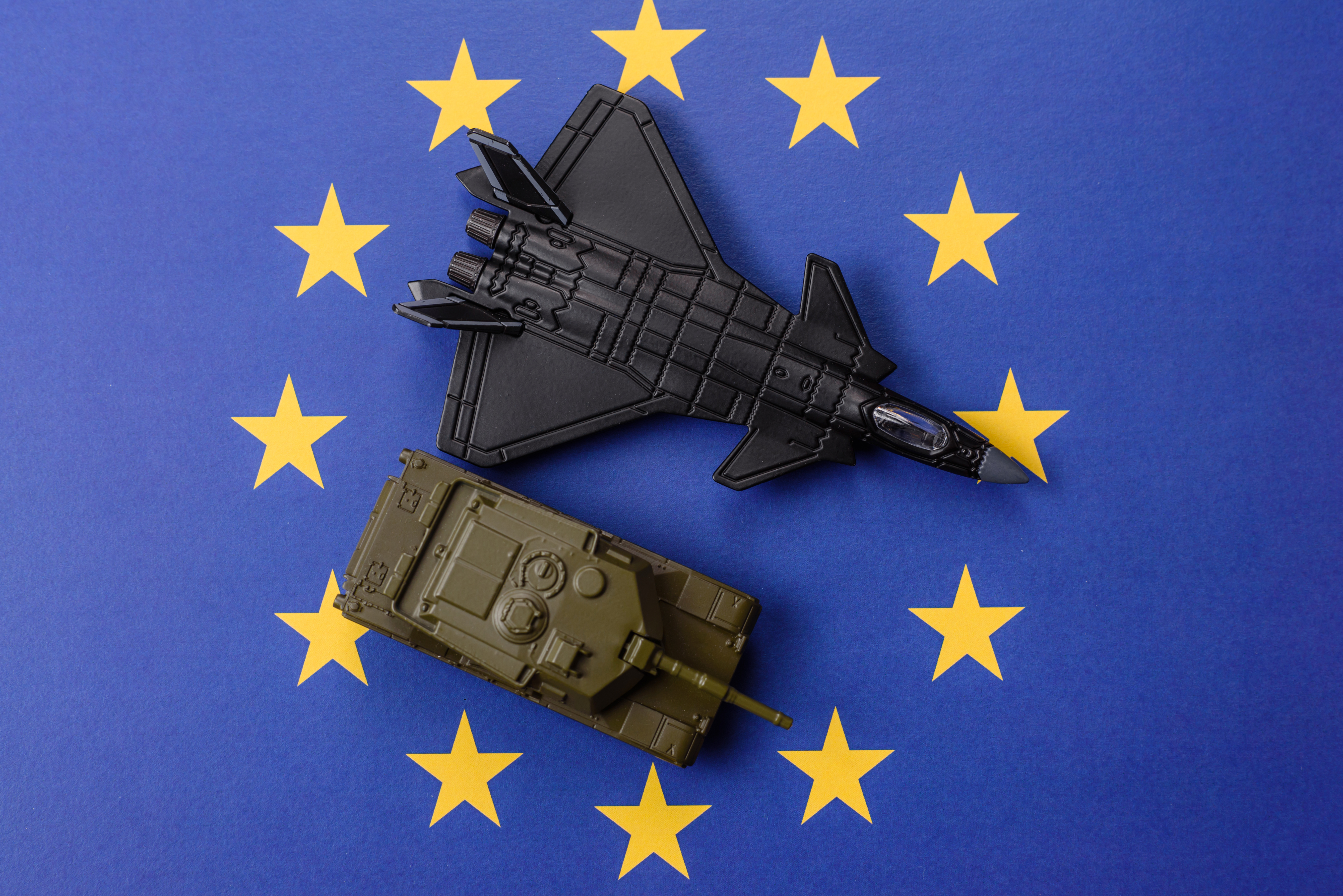 Maquettes d’un char et d’avions de chasse posées sur un drapeau de l’Union européenne